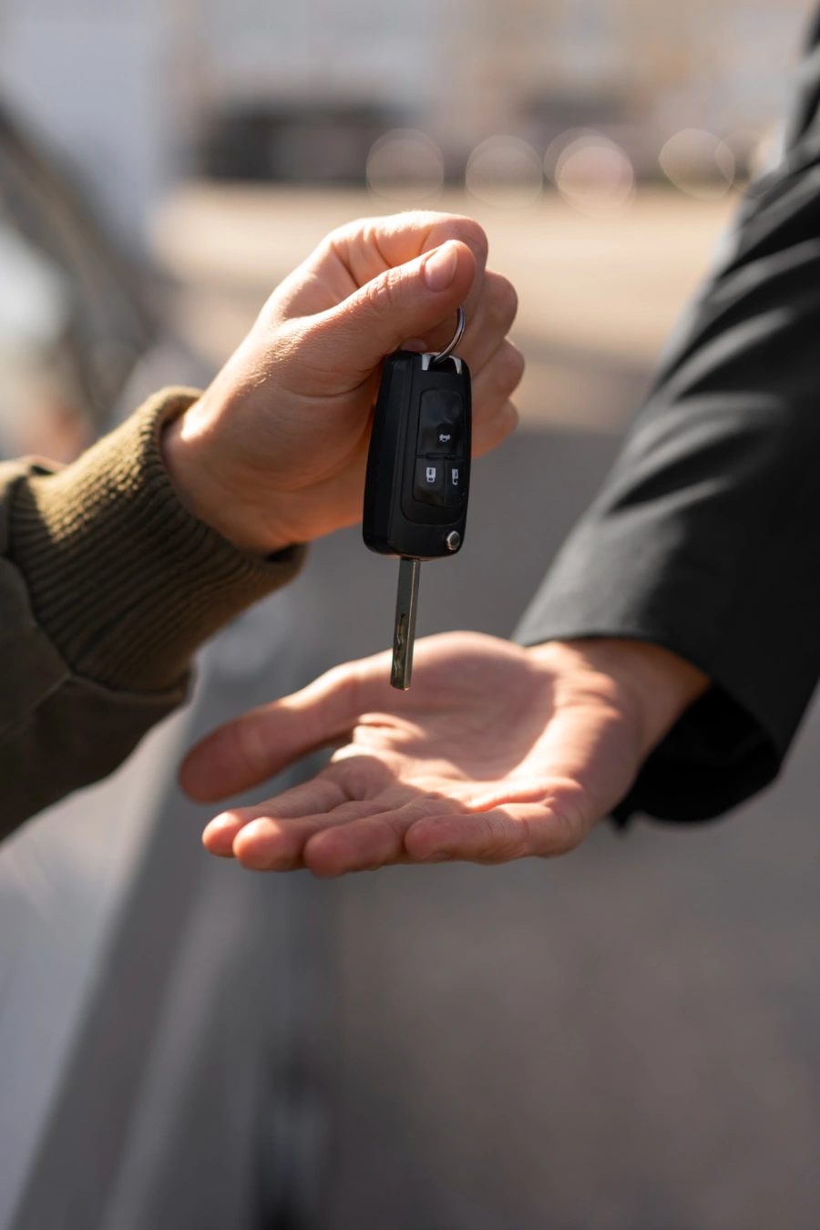a car key being passed on
